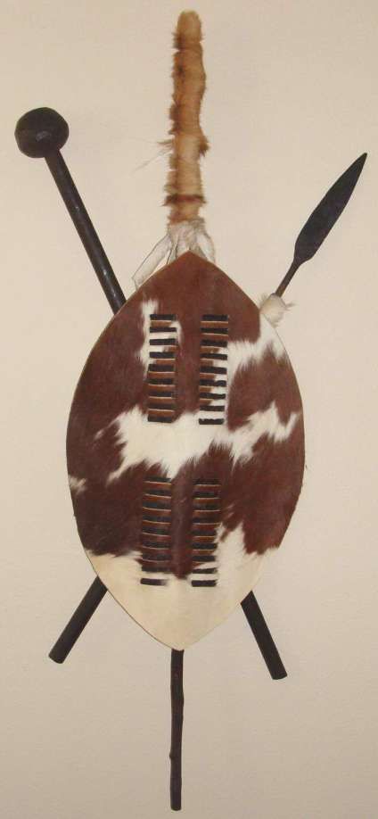 a brown and white hair comb on top of a round object with two black handles