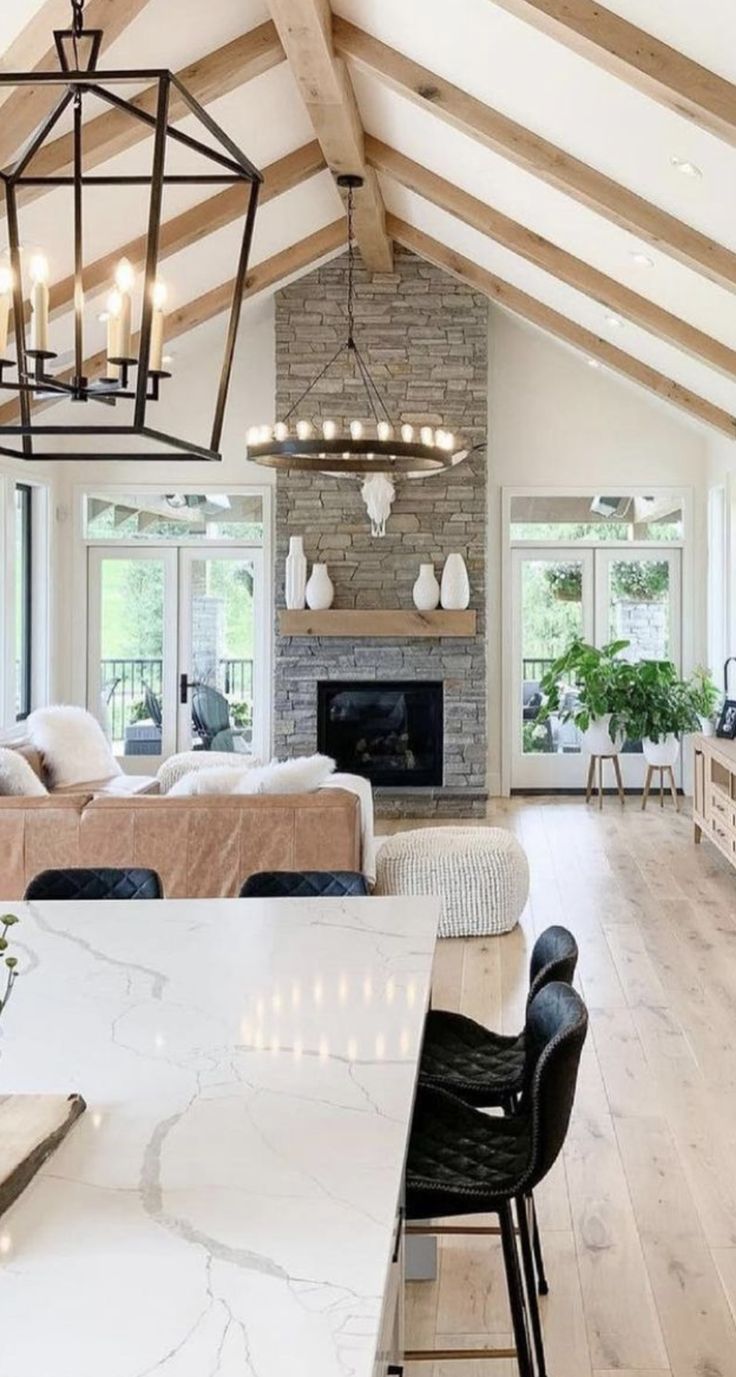 a living room filled with furniture and a fire place in the middle of a room