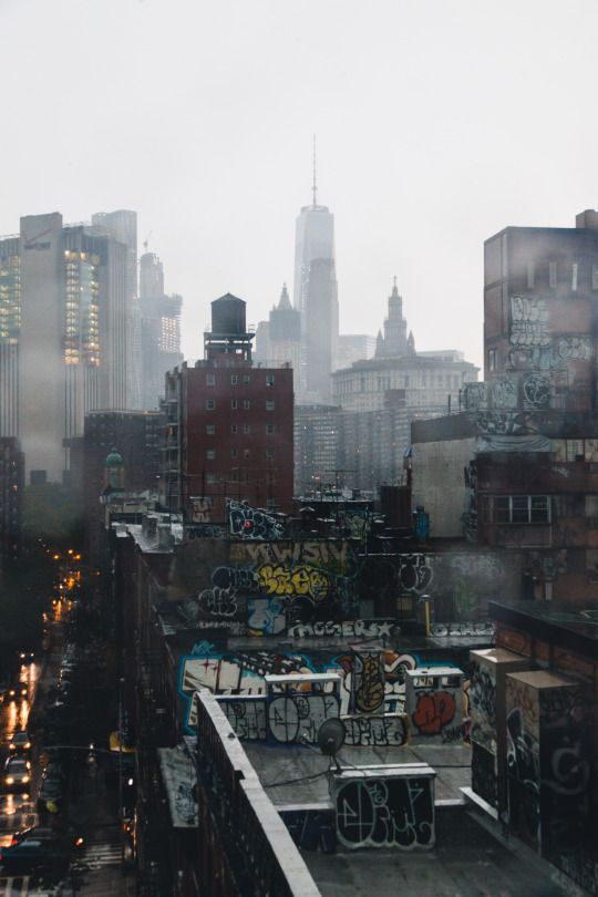 the city skyline is covered in graffiti and buildings