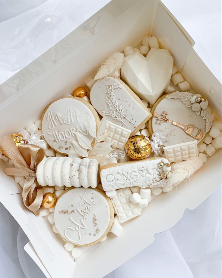 a white box filled with lots of different types of cookies