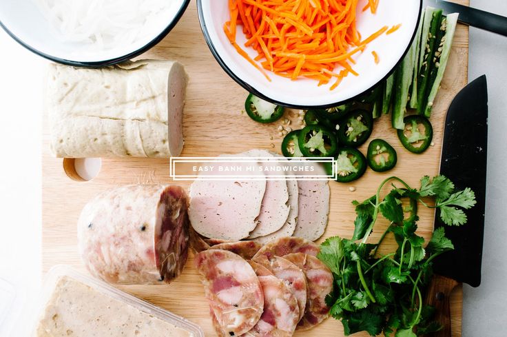 sliced meats and vegetables on a cutting board