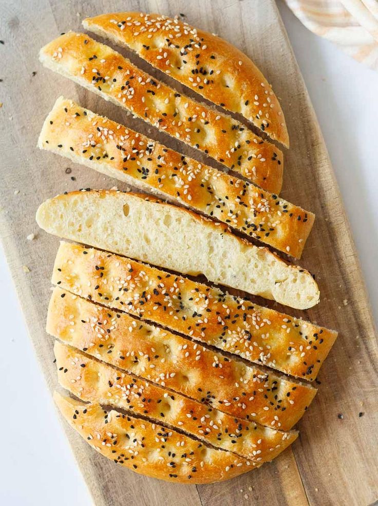 sesame seed bread sliced on a cutting board