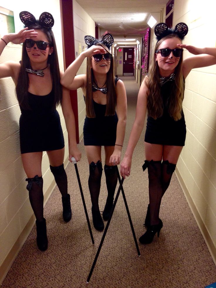 three girls dressed up as minnie mouse ears