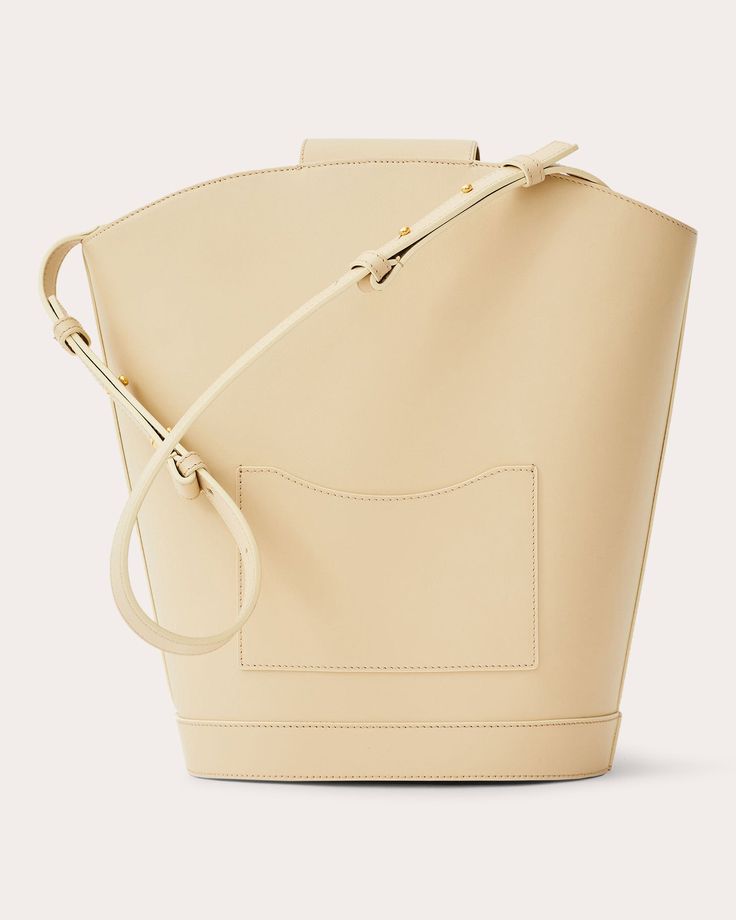 A nod to photographer Vivian Maier, this Objets Daso bag juxtaposes expressive shapes with refined details to create an elegant bucket design. The calfskin leather silhouette features polished goldtone hardware and a signature push-lock closure for elevated appeal. Signature push-lock closure Adjustable shoulder strap Goldtone hardware One interior and one exterior pocket Outer: 100% calfskin leather Lining: 100% lambskin leather Store in dust bag Made in Italy Measurements Width: 8.26in Height: 12.4in Depth: 5.9in | Objets Daso Women's Vivian Bucket Bag in Ivory | Leather Beige Smooth Grain Bucket Bag Tote, Classic Calf Leather Bucket Bag For Shopping, Luxury Cream Bucket Bag, Cream Bucket Bag With Detachable Strap For Office, Modern Calf Leather Bucket Bag With Double Handle, Modern Cream Bucket Bag With Detachable Strap, Classic Calf Leather Bucket Bag With Detachable Strap, Chic Rectangular Calf Leather Bucket Bag, Classic Calf Leather Bucket Bag With Detachable Handle