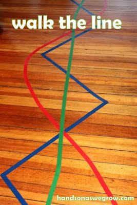 the words walk and drive tape roads on a wooden floor with colorful streamers coming out of it