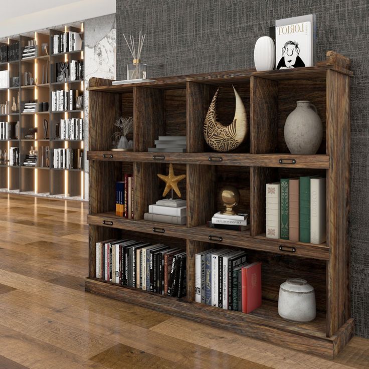 a bookshelf filled with lots of books on top of a hard wood floor