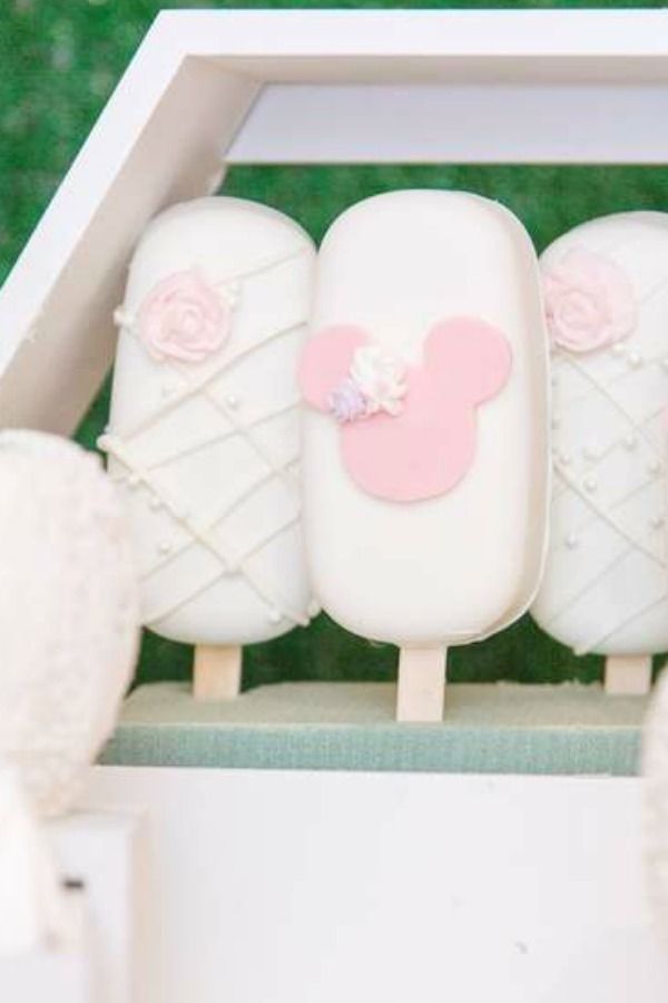 three marshmallows in a white box with pink decorations