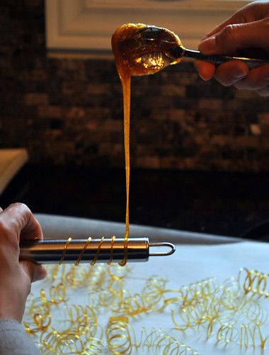 a person holding a spoon with some food on it and sauce pouring out of it