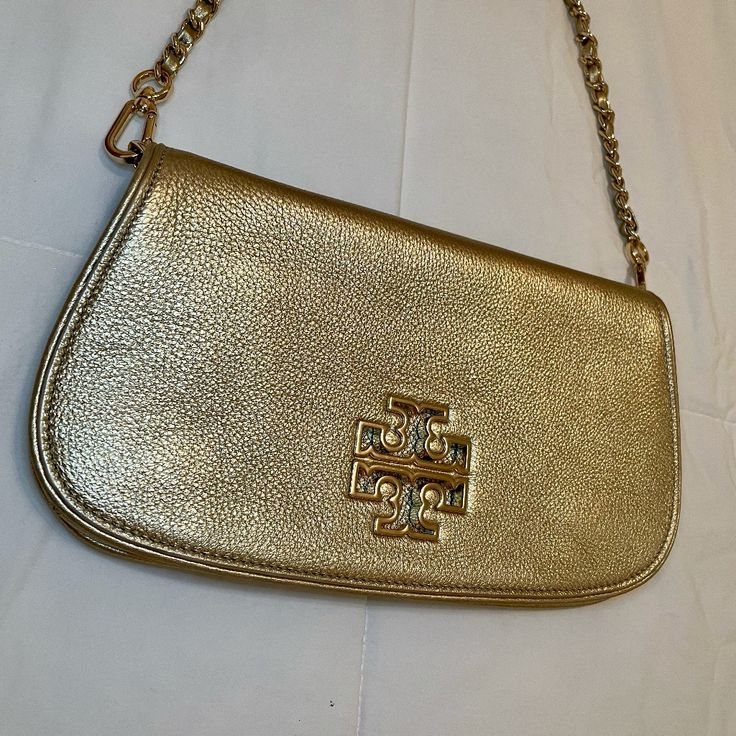 - Tory Burch - Authentic - Gold - Never Used (Still With Tag) - Leather - One Minor Imperfection In The Leather (Not Noticeable) Designer Gold Crossbody Clutch, Gold Leather Shoulder Clutch, Tan Textured Leather Crossbody Bag, Classic Gold Pouch Shoulder Bag, Tan Crossbody Shoulder Bag For Evening, Gold Leather Shoulder Evening Bag, Gold Leather Evening Shoulder Bag, Formal Tan Clutch Bag, Tan Textured Leather Shoulder Bag For Evening