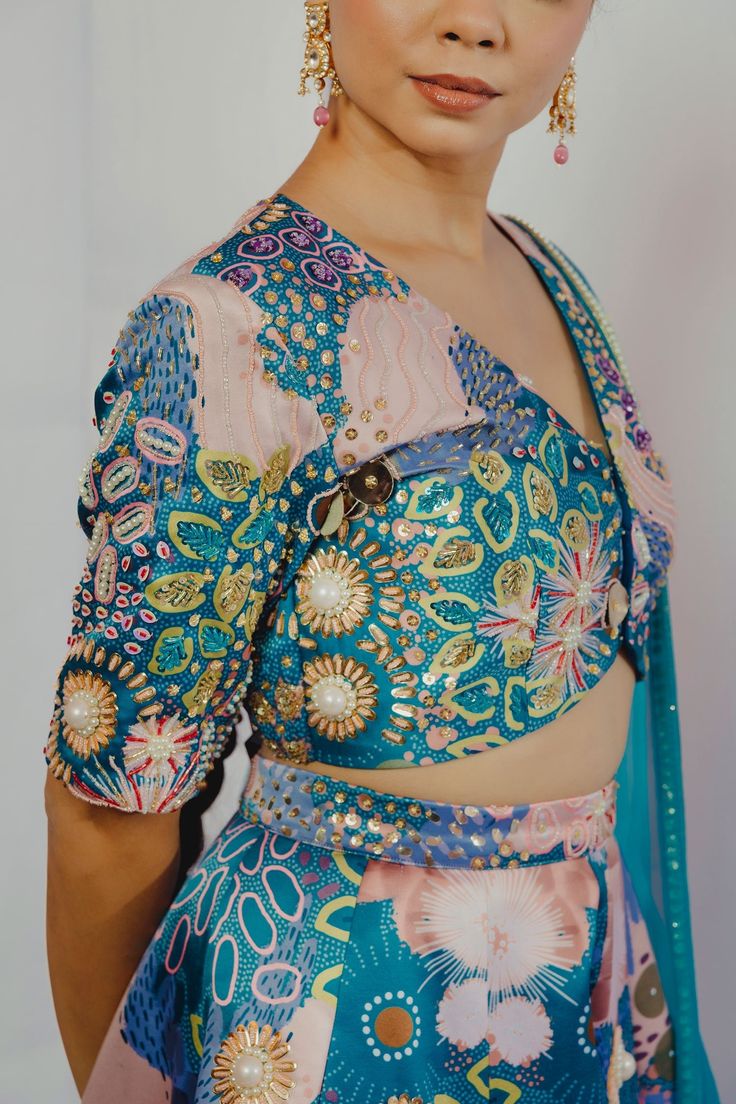 Turquoise lehenga with ocean print and bead embroidery. Paired with V neck blouse and dupatta.
Component: 3
Pattern: Printed, Embroidery
Type Of Work: Ocean, bead
Neckline: V neck
Sleeve Type: Half
Fabric: Imported Satin, Organza
Color: Blue, Green
Other Details: 
Inverted V hem
Note: Outfit worn by the model on right is not for sale
Closure: Blouse: Hook and eye
Occasion: Wedding - Aza Fashions Festive Turquoise Pre-draped Saree, Wedding Lehenga Hand Embellished In Multicolor, Multicolor Hand Embellished Lehenga For Reception, Designer Turquoise Saree Sets, Bollywood Turquoise Saree Set, Multicolor Hand Embellished Bollywood Sets, Hand Embellished Multicolor Bollywood Sets, Designer Turquoise Lehenga With Dupatta, Turquoise Fitted Saree With Zari Work