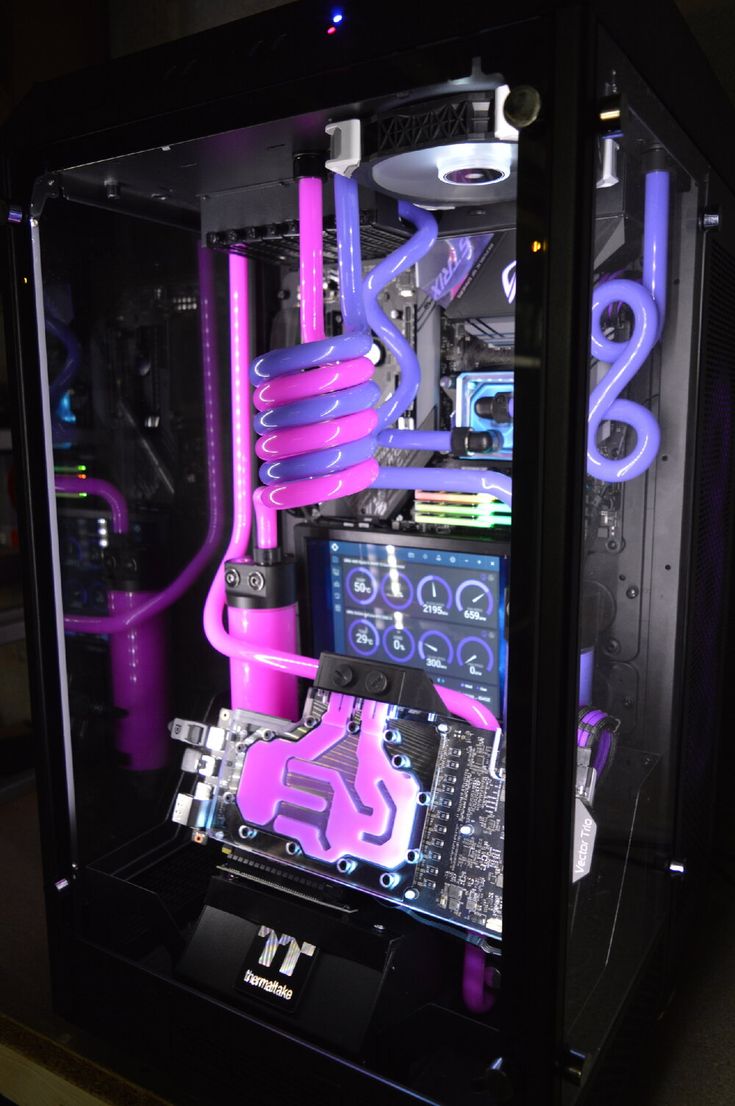 the inside of a computer case with purple pipes