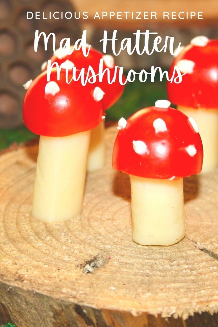 three red mushrooms sitting on top of a piece of wood with the words, delicious appetizer recipe mad - taten mushrooms