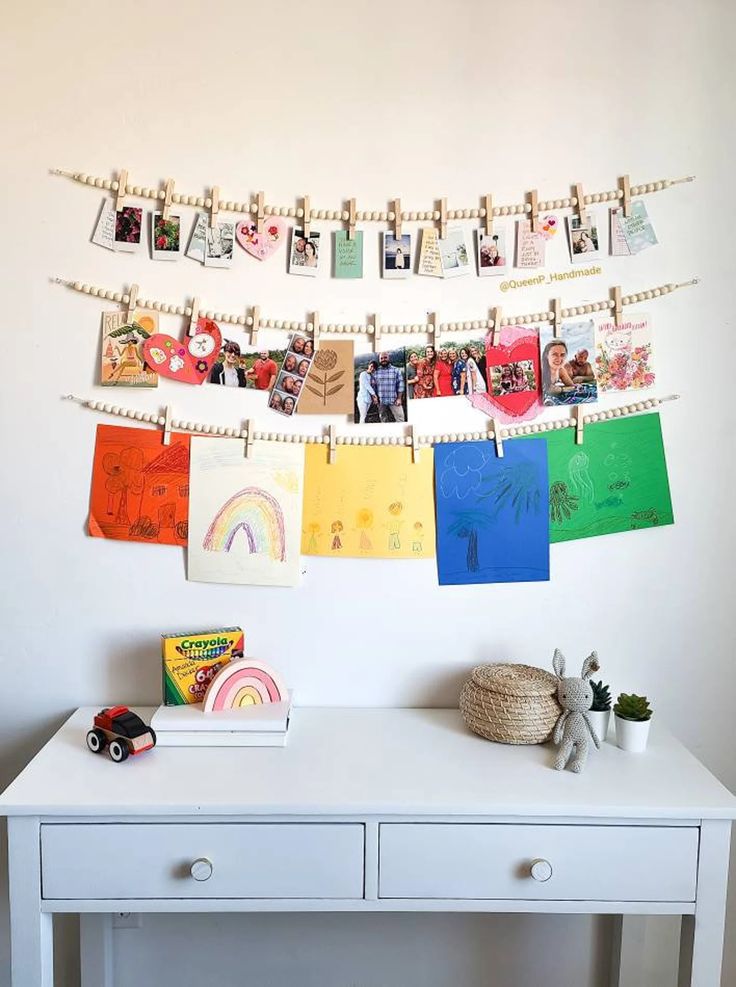 a white desk with pictures hanging on the wall