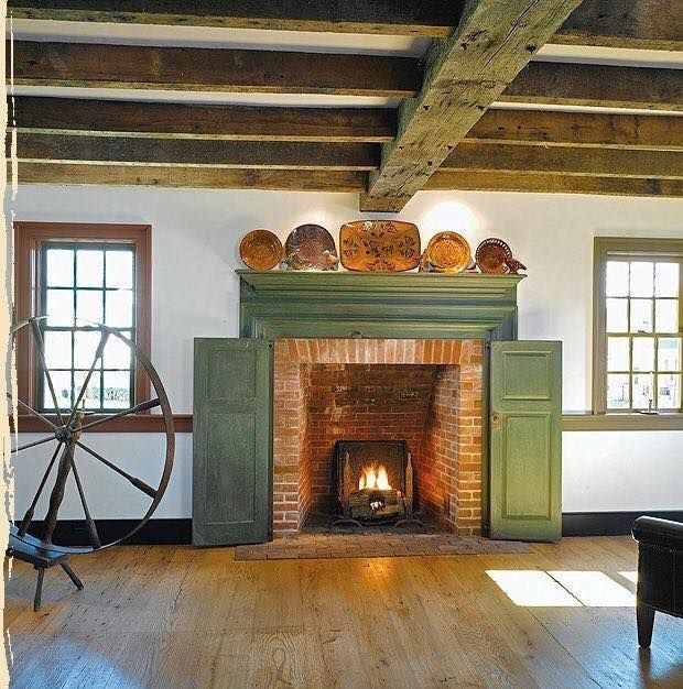 a room with a fire place and wooden floors