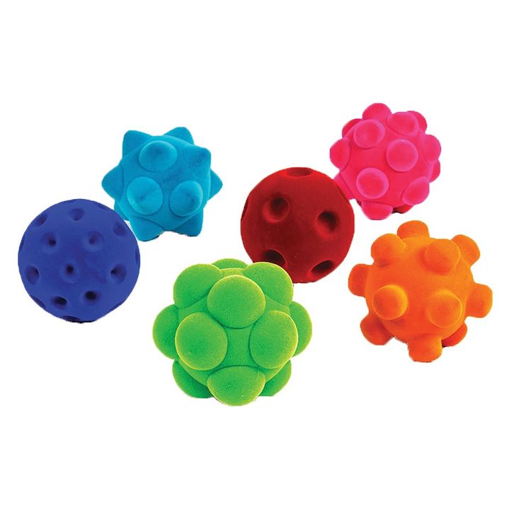 four different colored balls with holes in the middle