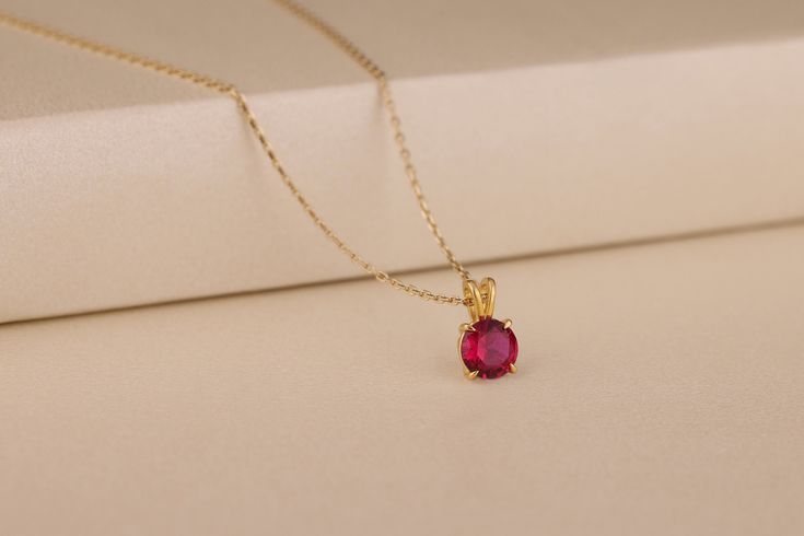 This is a stunning necklace made of solid 10K, 14k gold and silver. It has a round genuine red ruby gemstone with a timeless design and alluring luster, which is suitable for casual wear, business meetings, party occasions, and daily wear. This necklace will make an excellent gift for your wife or mother on her birthday, anniversary and other important occasions. Details of the product Material: 10K and 14K Solid Gold, Silver Gemstone: Ruby Gemstone Gemstone Size: 8 mm Unique Gift For people whom you love; Mom, Girlfriend, Wife, Fiance, Best Friend; Dainty Gift Idea; Valentine's Day Gift, Birthday Gift, Anniversary Gift, Gift For Engagement or Wedding, Promise Gift, Christmas Gift, Black Friday Gift, Mother's Day Gift, International Women's Day Gift, Memorial Gift. By gifting this elegant Classic Red 14k Gold Necklace, Elegant Ruby Round Pendant Jewelry, Yellow Gold Jewelry With Lab-created Ruby For Gift, Ruby Necklace With Prong Setting, Gold Jewelry With Lab-created Ruby As A Gift, Ruby Round Necklace With Prong Setting, Gift Necklace With Prong Setting And Lab-created Ruby, Gold Jewelry With Lab-created Ruby For Gift, Classic Necklace With Lab-created Ruby