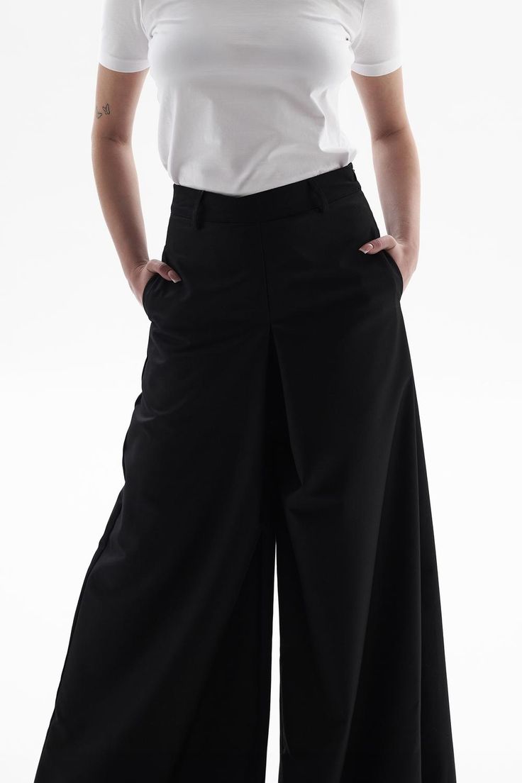 These pants are very versatile, perfect for both sneakers and heels. They are made from a dense poly-viscose fabric, with side seam pockets and a hidden zipper at the back. Versatile Wide Leg Pants With Minimal Stretch, Modern Pants With Pockets In Elastane, Modern Elastane Bottoms With Pockets, Modern Elastane Pants With Pockets, Modern Stretch Wide-leg Pants, Wide Leg Work Pants With Minimal Stretch, Modern Stretch Wide-leg Bottoms, Wide Leg Pants With Minimal Stretch For Work, Modern Wide Leg Pants With Minimal Stretch