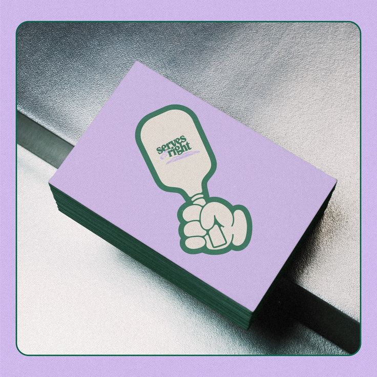 a purple business card with an image of a hand holding a light bulb on it