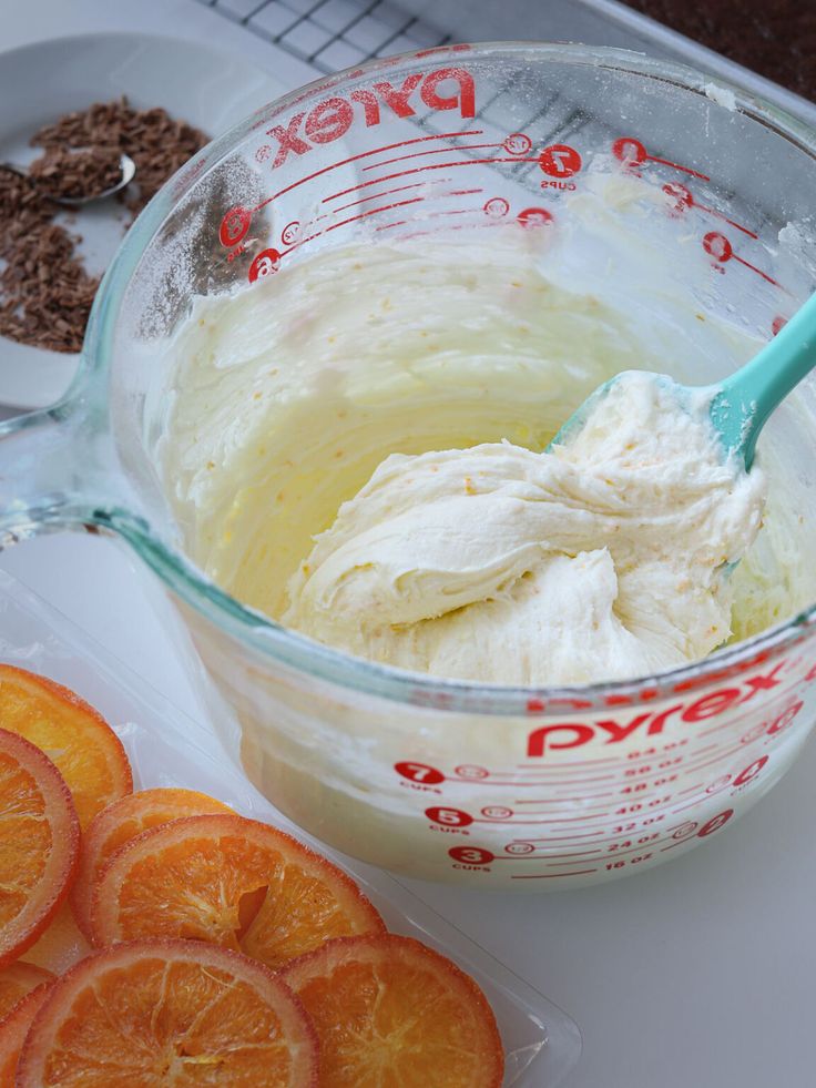 orange slices and cream in a measuring cup