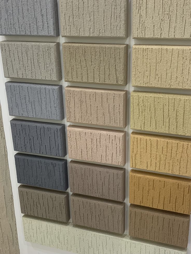 several different colors of carpet tiles on display in a room with white walls and flooring