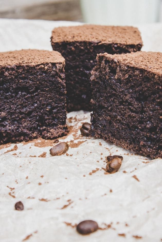 two pieces of chocolate cake sitting on top of a table