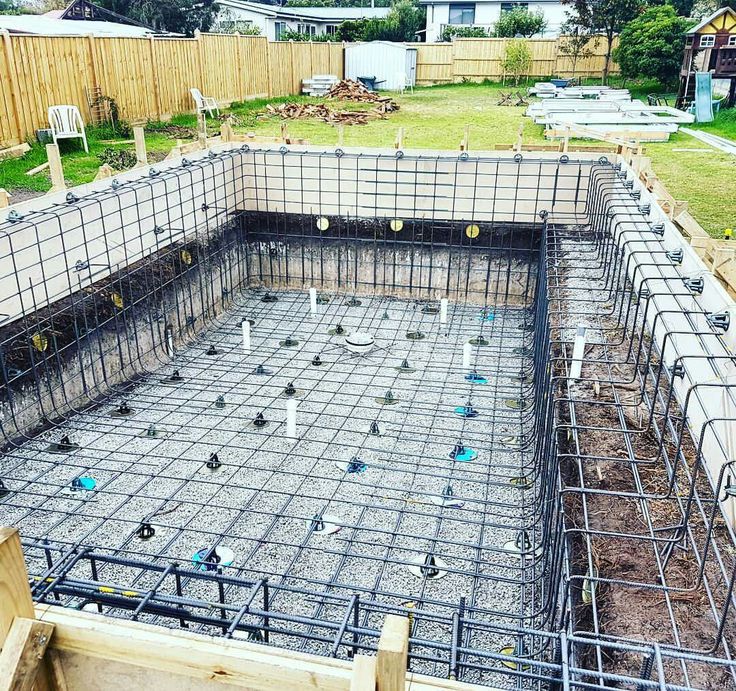 the foundation for a house being built with concrete and steel bars in place to support it