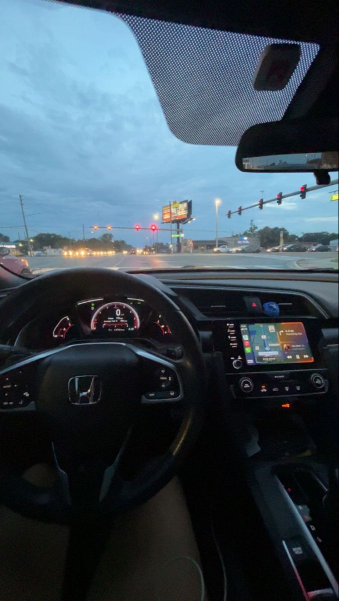 the interior of a car with dashboard lights and steering wheel view from driver's seat