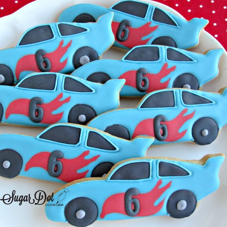 decorated cookies in the shape of cars on a plate