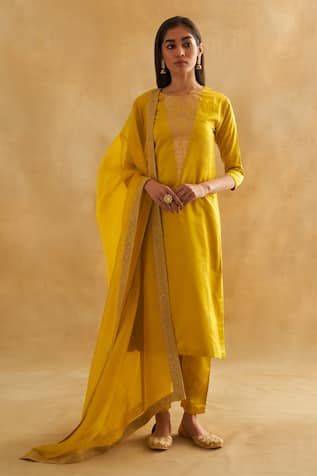 Mustard yellow kurta with bird and botanical motif embroidery in katan silk base. Paired with a cigarette pant and pure Indian organza dupatta with an embroidered border. - Aza Fashions Yellow Chanderi Palazzo Set With Embroidered Border, Yellow Anarkali Palazzo Set With Embroidered Border, Yellow Embroidered Palazzo Set For Festivals, Yellow Palazzo Set With Embroidered Border For Diwali, Diwali Yellow Palazzo Set With Embroidered Border, Diwali Yellow Embroidered Palazzo Set, Yellow Embroidered Slub Silk Unstitched Suit, Yellow Embroidered Unstitched Slub Silk Suit, Yellow Tissue Silk Kurta For Diwali