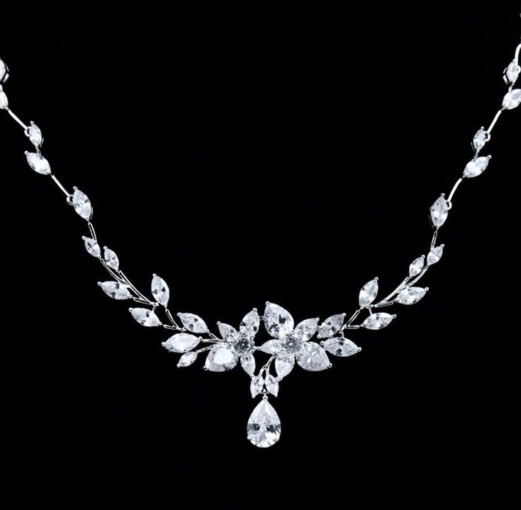 A beautiful two-piece bridal jewelry set with an incredible sparkle! Adorned with intricately faceted cubic zirconia that capture the light from every angle with a perfectly translucent appeal, the pieces are platinum plated for a flawless finish which enhances the intricate detailing and conveys a modern take on old elegance. Necklace: 17" (approx. 43cm) long with a secure fold-over closure Earrings: 1.5" (approx. 4cm) long and come with sturdy backs Hypoallergenic - lead, nickel and cadmium fr Silver Bridal Sets With Diamond Accents, Bridal Silver Necklace With Brilliant Cut Cubic Zirconia, Silver Cubic Zirconia Bridal Accessories, Silver Diamond Bridal Set With Sparkling Stones, Silver Cubic Zirconia Bridal Sets With Elegant Design, Silver Cubic Zirconia Bridal Accessories For Anniversary, Silver Crystal Bridal Set With Diamond Cut, Elegant Silver Cubic Zirconia Bridal Sets, Pear-shaped Cubic Zirconia Wedding Necklace