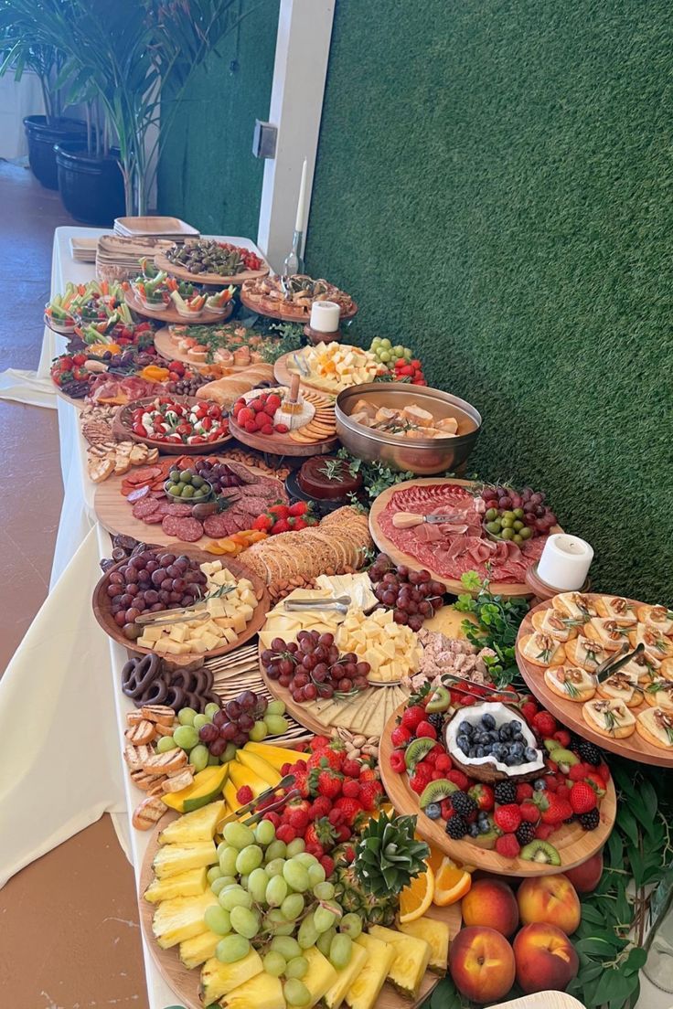 a long table filled with lots of different types of food on top of each other