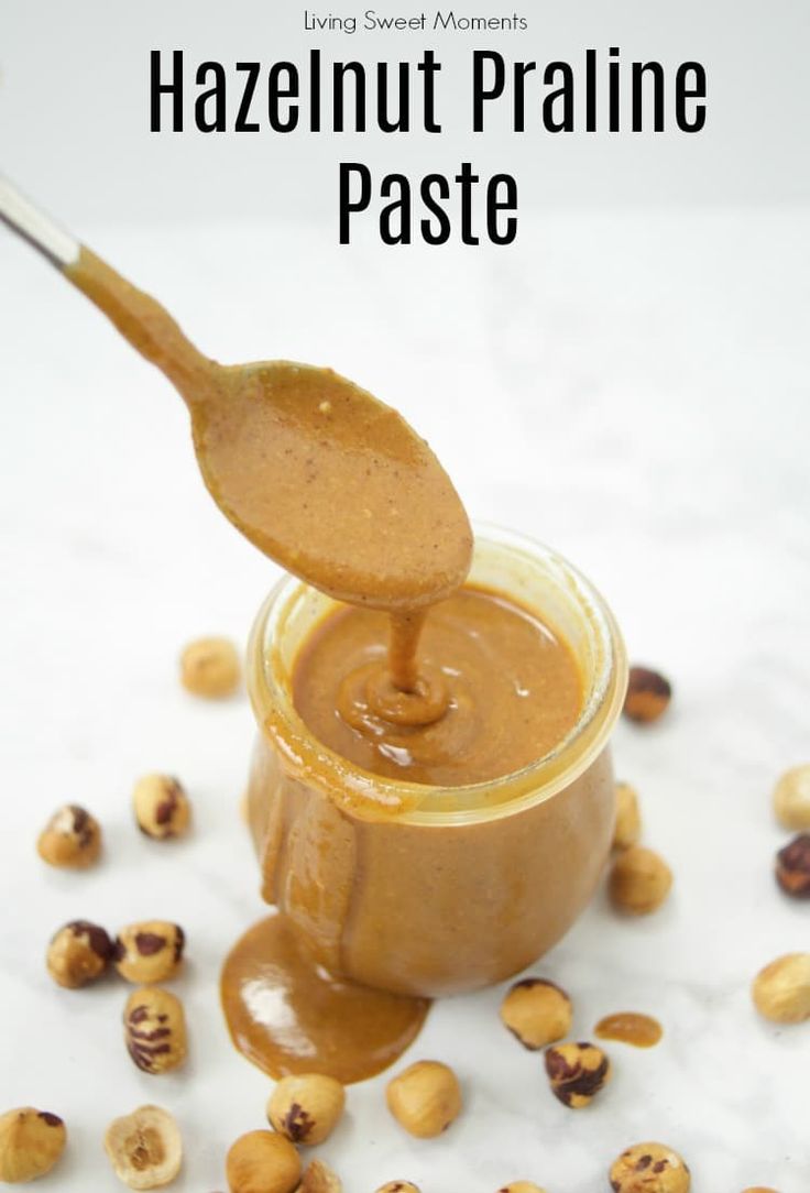 hazelnut pralie paste in a glass jar with a spoon full of peanut butter