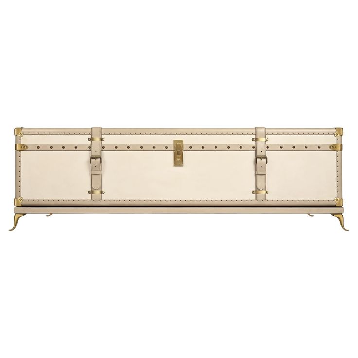 a white trunk with gold trimmings and studded handles