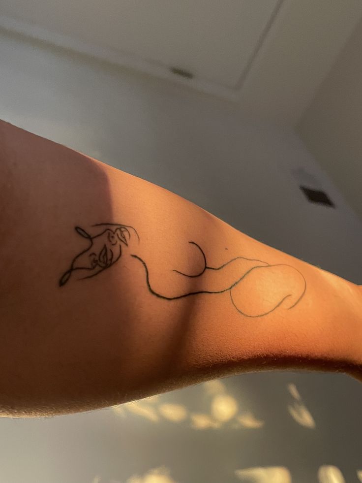 a person's arm with a tattoo on it that has a horse drawn on it