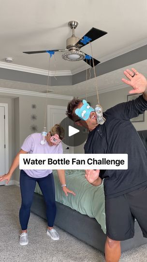 a man and woman are playing with water bottles