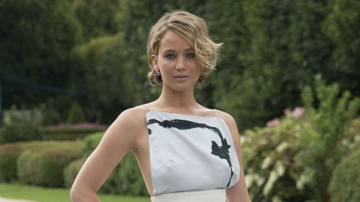 a woman in a white and black dress posing for the camera