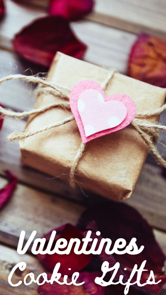 valentine's day cookie gifts on a wooden table with pink hearts and twine