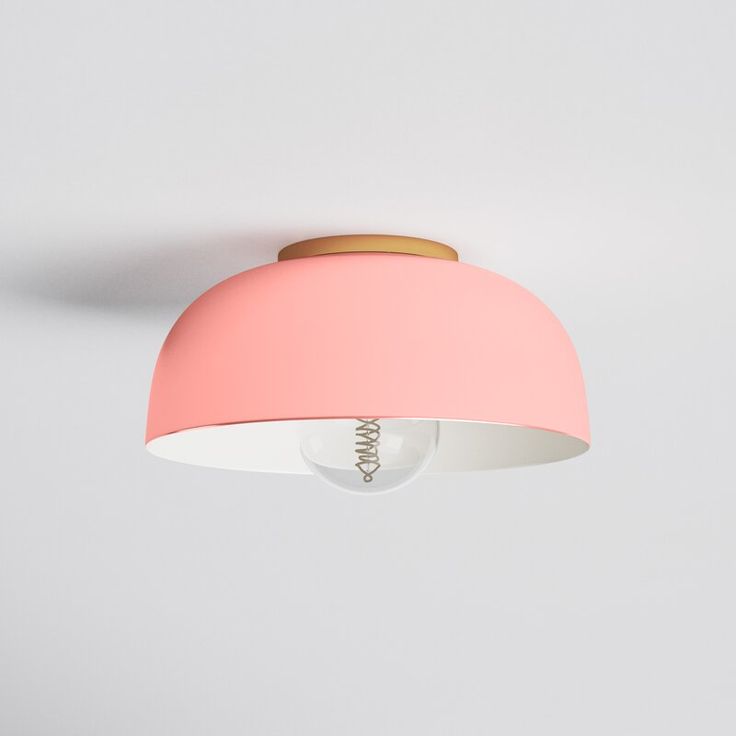 a pink ceiling light hanging from the ceiling with a white wall in the back ground