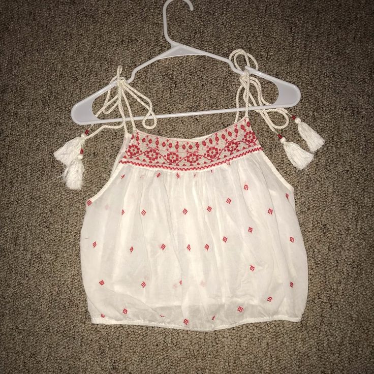 Nwot! This Free People Tank Top Is So Cute And Has The Most Beautiful Details On It. It Has Adjustable Tie Straps With Little Pom Poms At The End. It Is White White Red Embroidery On It. I Bought It Last Year So It Is No Longer Sold At Free People. Cute Embroidered Tops For Vacation, Casual Red Tops With Floral Embroidery, Cute Embroidered Beach Tops, Cute Red Tops With Floral Embroidery, Casual Red Embroidered Top, Free People Tank, Embroidered Tank, Free People Tank Top, Red Embroidery