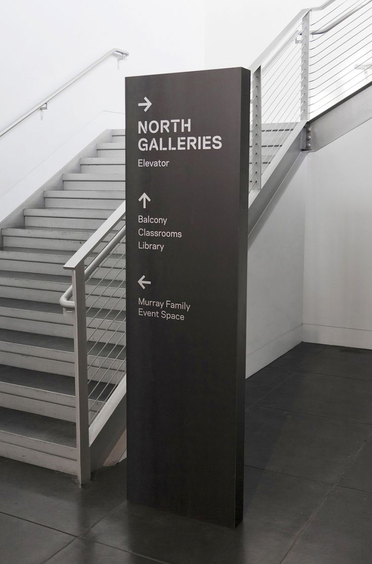 a sign that is in front of some stairs and railings with the words north gallerys on it