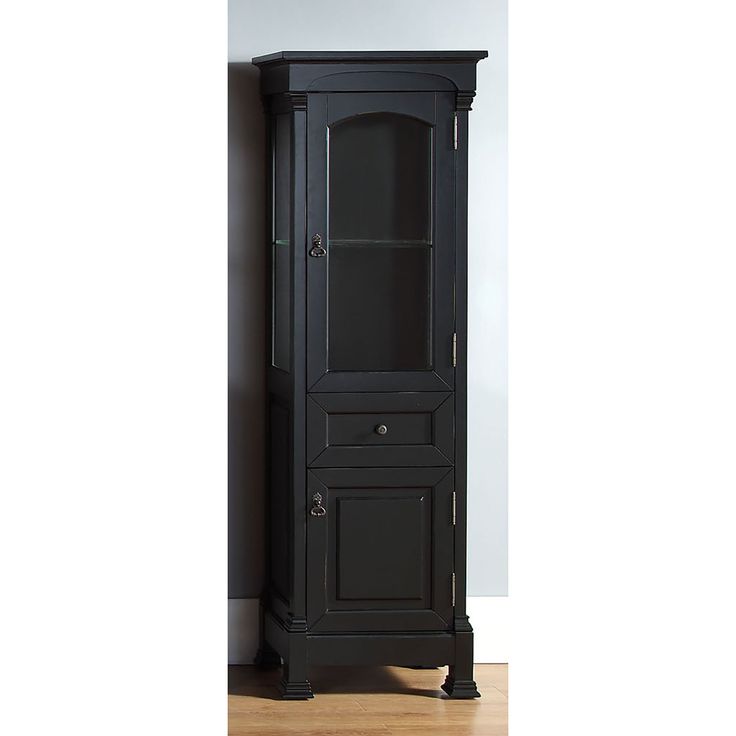 a tall black cabinet sitting on top of a hard wood floor