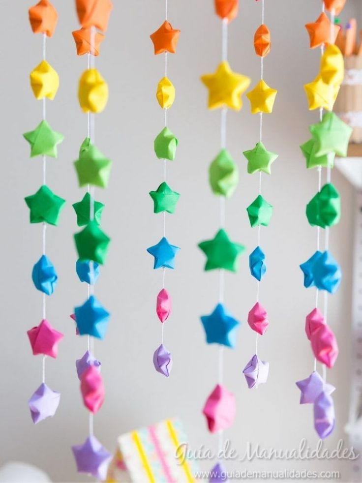 a colorful mobile with stars hanging from it's sides