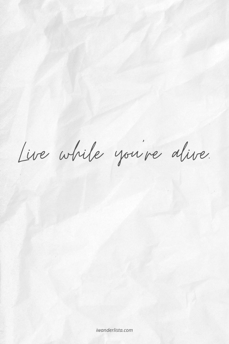 the words live while you're alive written on white paper