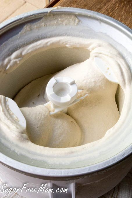 a close up of a food processor on a table with some kind of cream in it