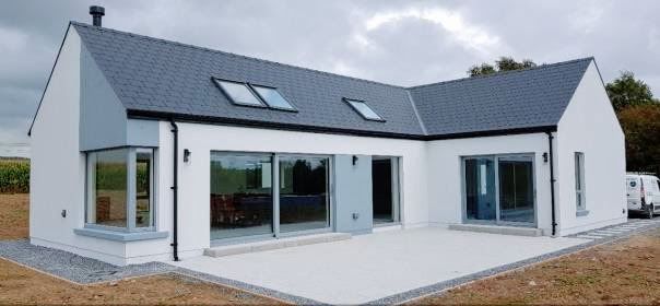 a white house with two windows on the roof