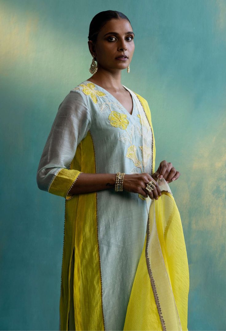 Editor's Note This Kurta Set Is Beautifully Crafted In One Of The Finest Layers Of Handwoven Chanderi Fabric. The Colour Block Composition That Comes In Subtle Shade Of Sage Green And Bright Yellow Colours. The Main Highlight Of The Design Is The Floral Thread And Beads Hand Embroidery That Falls Gracefully On The Neckline. The Set Comprises Of Straight Sage Green Cotton Pants With Floral Embroidery Around The Hem. This Exquisite Look Is Completed With A Rich Yellow Kota Silk Dupatta Embellished Green Cotton Pants, Yellow Kurta, Embroidery Leaf, Kurta Set For Women, Embroidered Dupatta, Boutique Dress Designs, Beaded Neckline, Silk Dupatta, Lace Border