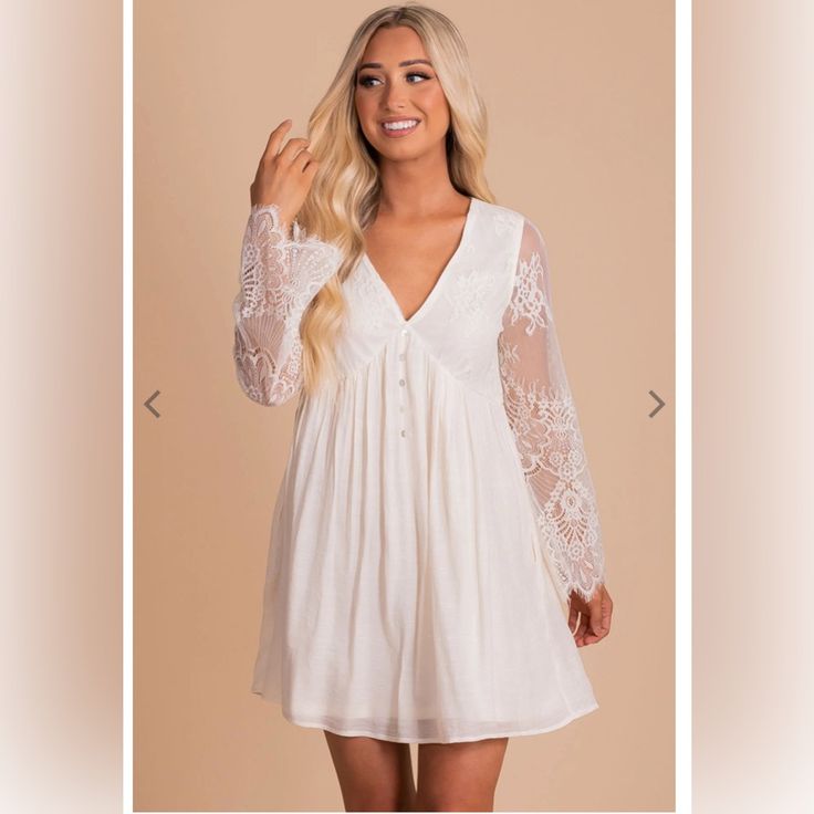 You'll Look And Feel Beautiful In Our New Can't Say Goodnight Mini Dress! This Mini-Length Dress Features Floral Lace Detailing On The Bodice And Sleeves. The V-Neckline, Complete With Adorable Decorative Buttons, Adds A Unique Touch! We're In Love With The Subtle Pleated Accents And Partial Lining. Can't Say Goodnight Mini Dress Is Composed Of 100% Polyester; 65% Rayon 35% Polyester Contrast. V-neck Day Dresses With Lace Sleeves, Flowy Dresses With Lace Sleeves, V-neck Dresses With Lace Sleeves For Daywear, V-neck Dress With Lace Sleeves For Daywear, White Dresses With Lace Sleeves For Night Out, Say Goodnight, Decorative Buttons, Off White Color, Boutique Dresses