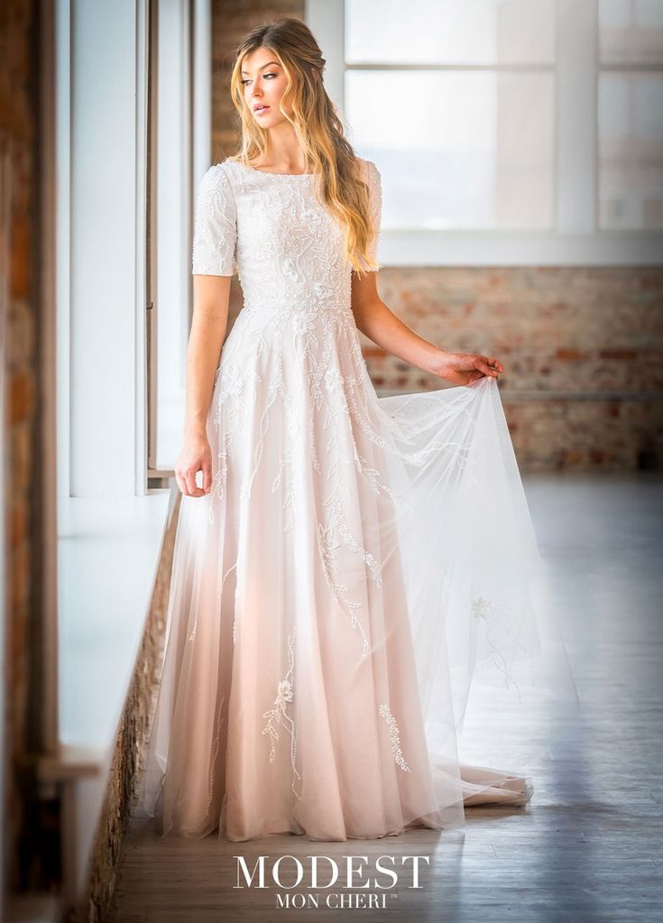 a woman in a wedding dress holding a veil