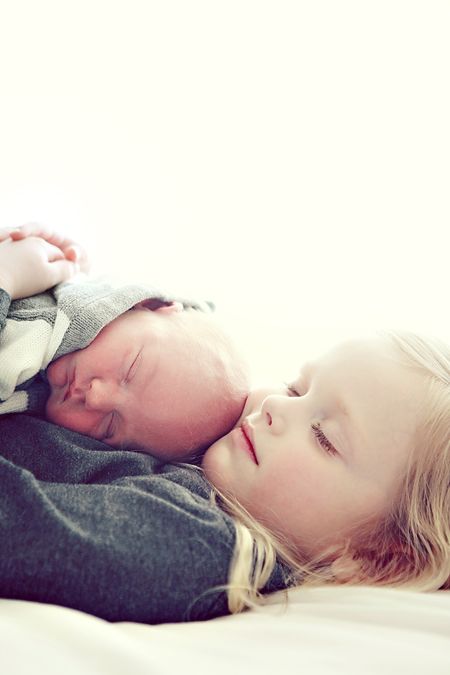 two young children laying on top of each other