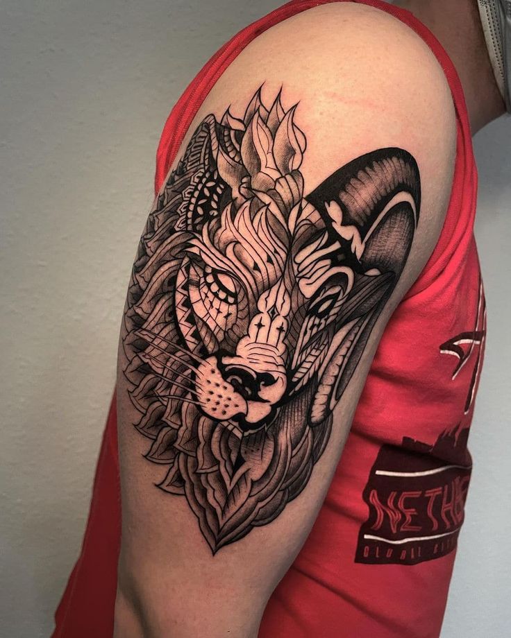 a man's arm with a tattoo on it and a lion head in the middle